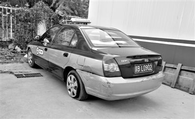 昨日，被撞爆胎的“克隆”出租車，停在朝陽(yáng)交通支隊(duì)奧運(yùn)村大隊(duì)院內(nèi)。新京報(bào)記者 黃月 攝