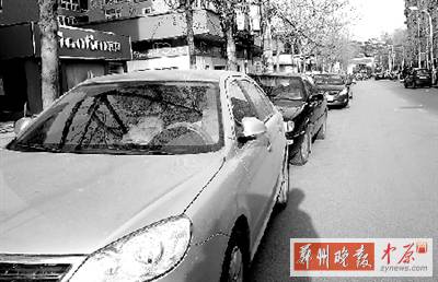 友愛(ài)路，路邊停了一排車，本來(lái)不寬的路就變得更窄了。