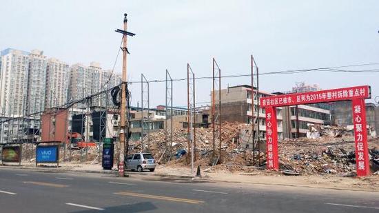 015年5月31日，在社區(qū)干部的帶頭拆遷下，親賢社區(qū)的“城中村改造”拉開帷幕。由于前期“清產(chǎn)核資”及補(bǔ)償標(biāo)準(zhǔn)等因素，拆遷改造工作推進(jìn)并不順利。圖為位于體育西路東側(cè)集體所有的商鋪率先被拆遷完畢，用于遮擋的圍擋正在施工中。（拍攝：2015年9月16日）