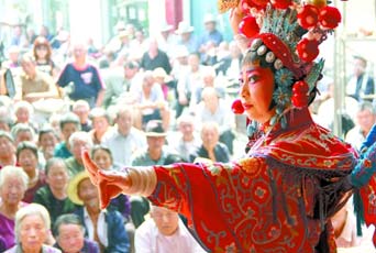 圖為8月15日戲曲演員在“流動舞臺車”上表演傳統(tǒng)地方戲《穆桂英下山》。
