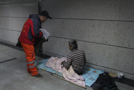 在鄭州一處地下通道，孫德坤挑了幾件衣服送給了流浪者