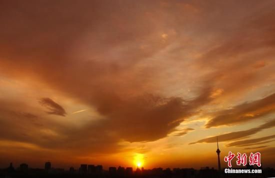 12月8日下午，強烈的西北風(fēng)光臨北京，吹散了籠罩全城上空的霧霾，冬日罕見的艷麗晚霞映紅了半邊天。