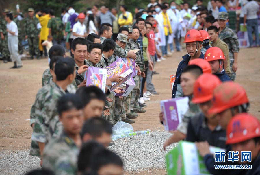 8月5日，在魯?shù)榭h龍頭山鎮(zhèn)，當?shù)孛癖D運從直升機上卸載的救災物資。